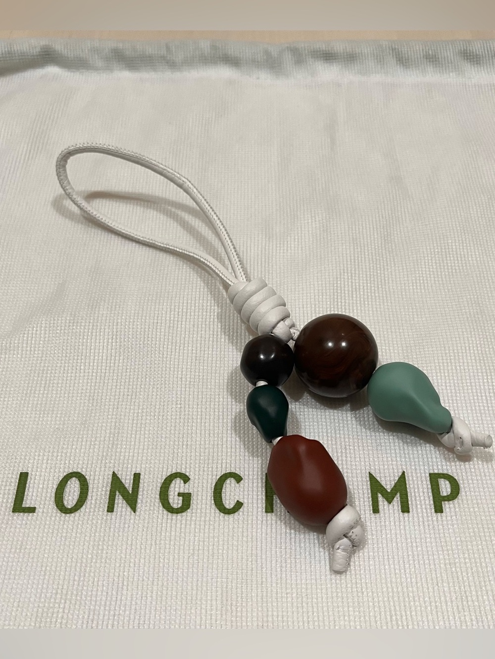 Longchamp bag charm from Le Pliage collection basket bag white leather & beads